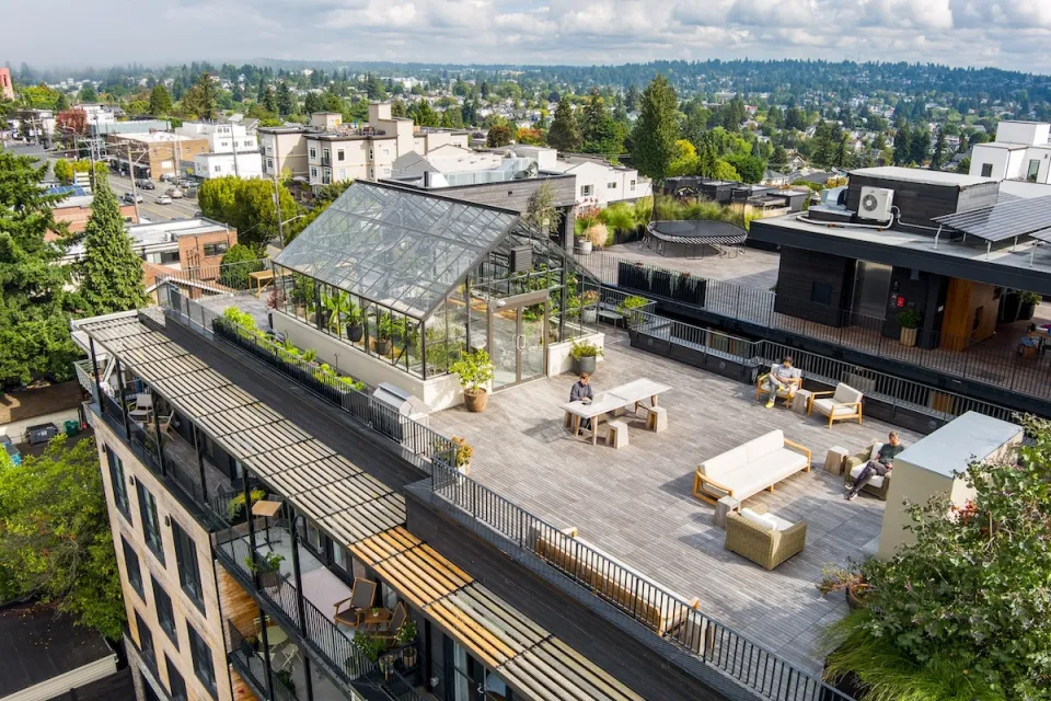Aerial view of Shared Roof apartment building in Seattle with glass greenhouse on roof.